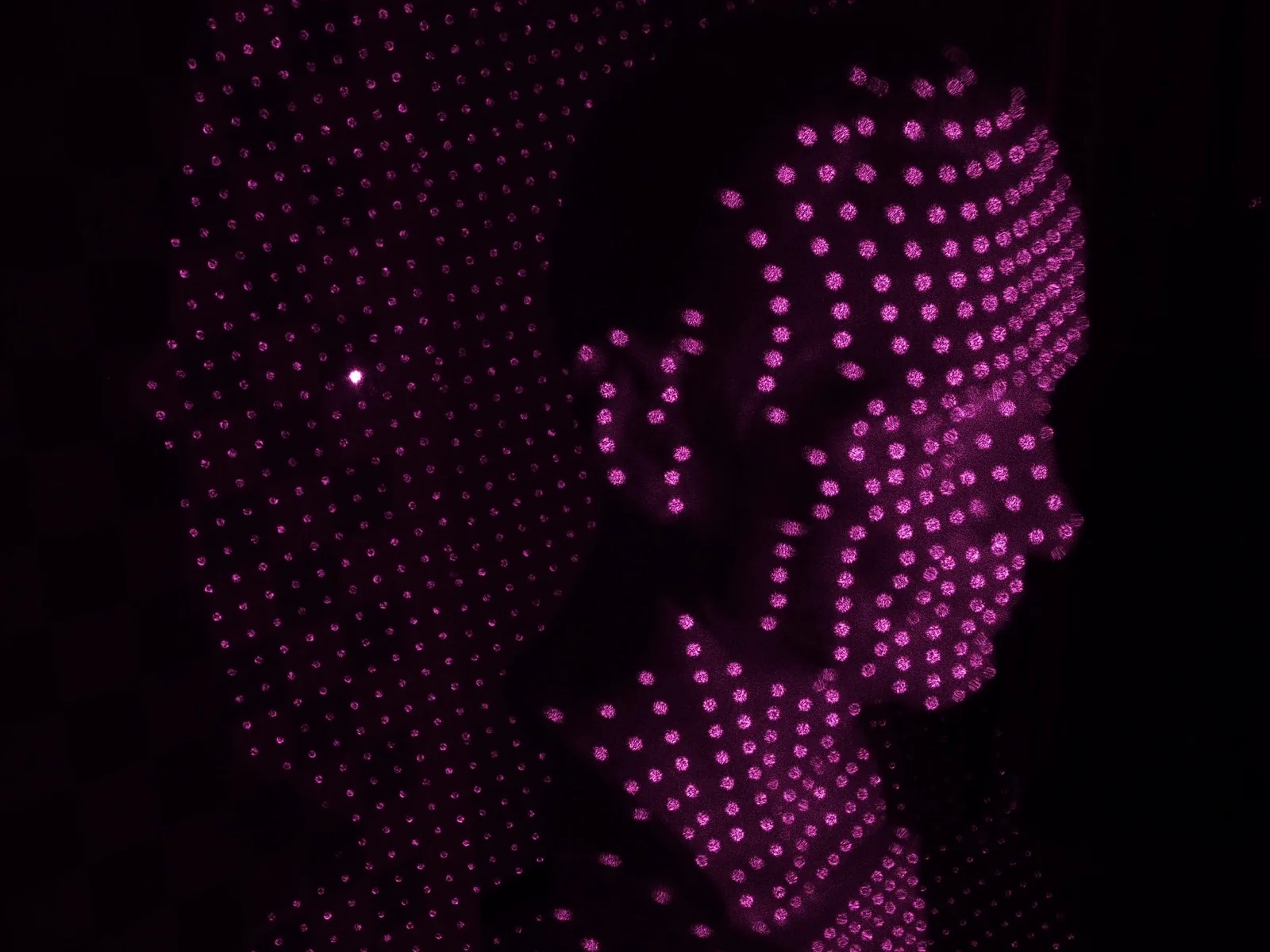 A dense colored 3D point cloud of a statue